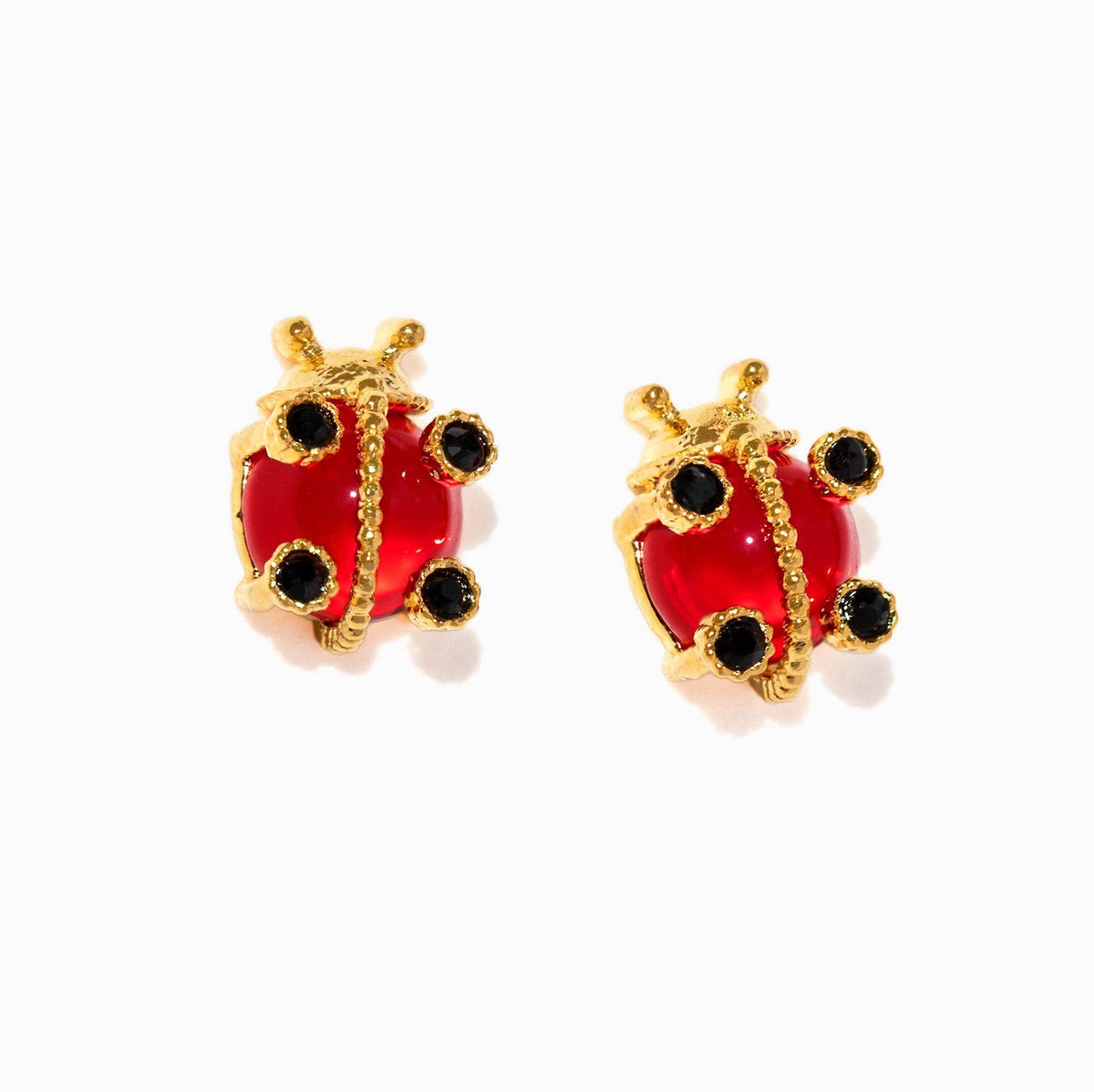 Gold ladybug earrings with red bodies and black spots on a white background
