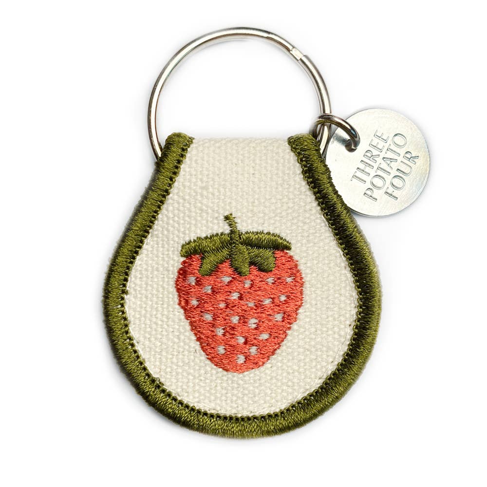 Keychain with embroidered strawberry design on a white background