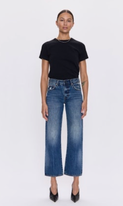Person wearing a black t-shirt and blue jeans on a white background