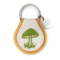 Keychain with embroidered green mushroom design on a white background
