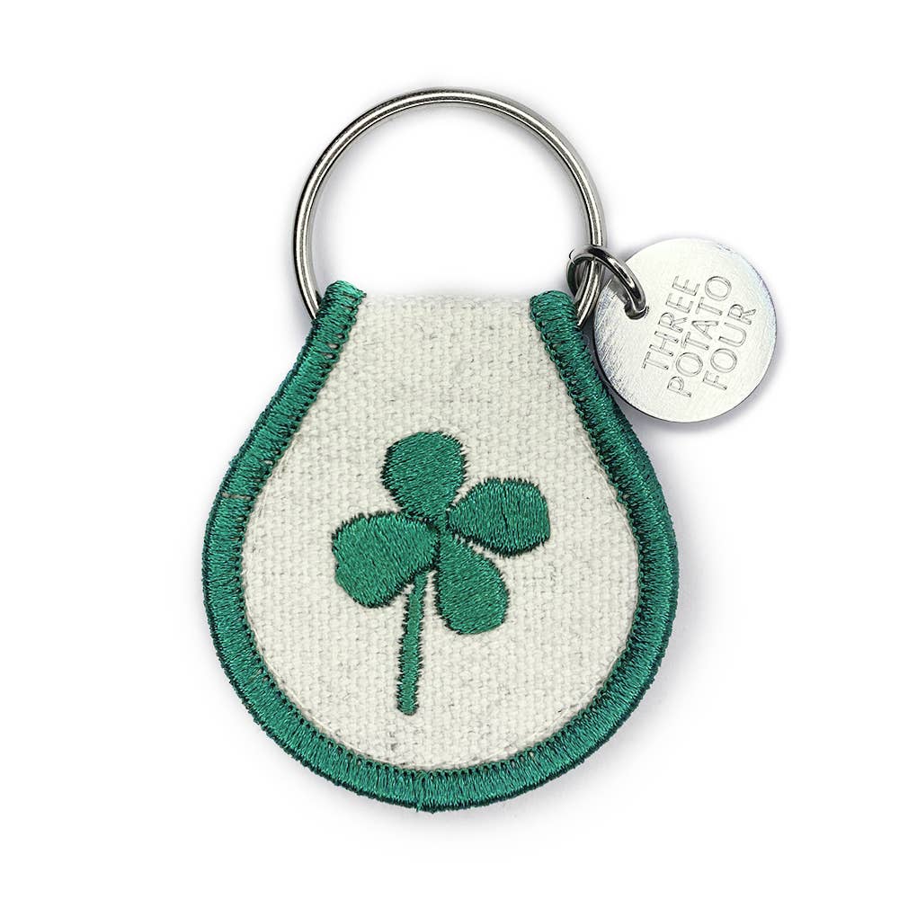 Keychain with green clover design on a white background