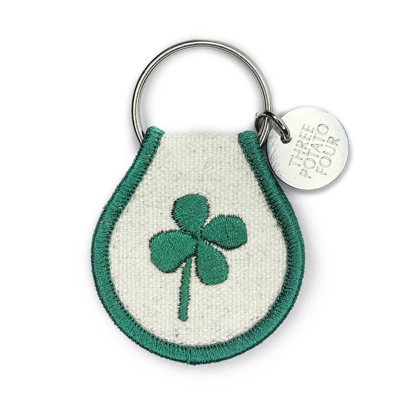 Keychain with green clover design on a white background